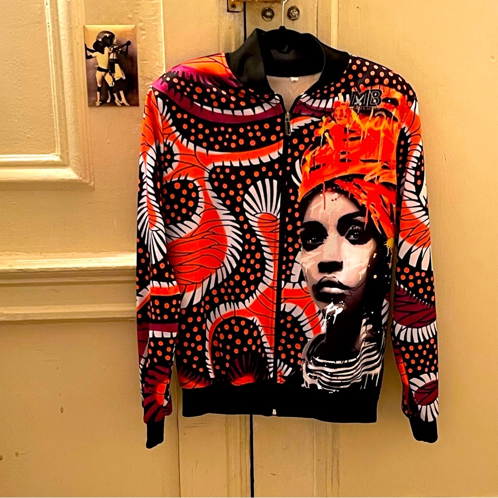 Custom made baseball jacket. Mix of vibrant colors, orange, black, white, etc.